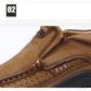 Close-up of brown suede sneaker showing lace eyelets and textured outsole edge