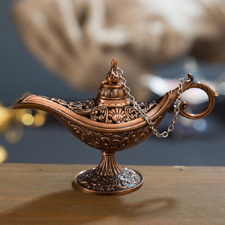 Copper-brown metal wish lamp with detailed engraving, top ornament, and chain