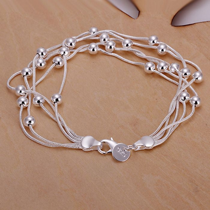 Silver plated beaded bracelet with multiple wire strands and ball charms, heart clasp