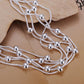 Silver plated multi-strand bracelet with dangling round bead charms and knot-style links