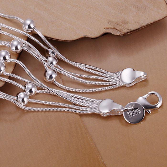 Silver plated multi-strand bracelet with heart-shaped clasp and circular 925 charm tag