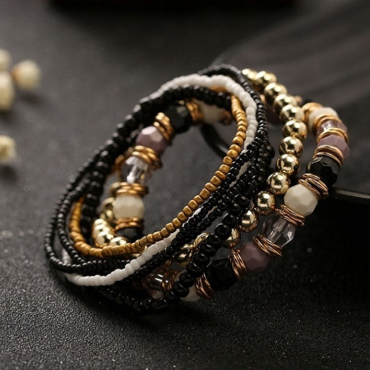 Multi-layer beaded elastic bracelet with black, gold, cream beads and bronze spacers