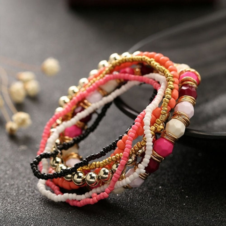 Multi-layer beaded elastic bracelet with coral, pink, white, and gold beads