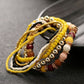 Multi-layer beaded elastic bracelet with yellow, gold, black, and brown beads