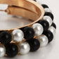 Girls hoop pearl earrings close-up: black, white, and gold beaded fringe on hoop