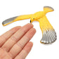 Yellow and gray eagle balance bird toy held in hand, with gray wing details