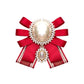 Red satin bow brooch with oval pearl cabochon and rhinestone border, double pearl detail