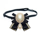 Black fabric bow brooch with oval pearl centers, rhinestone border, attached to a belt strap