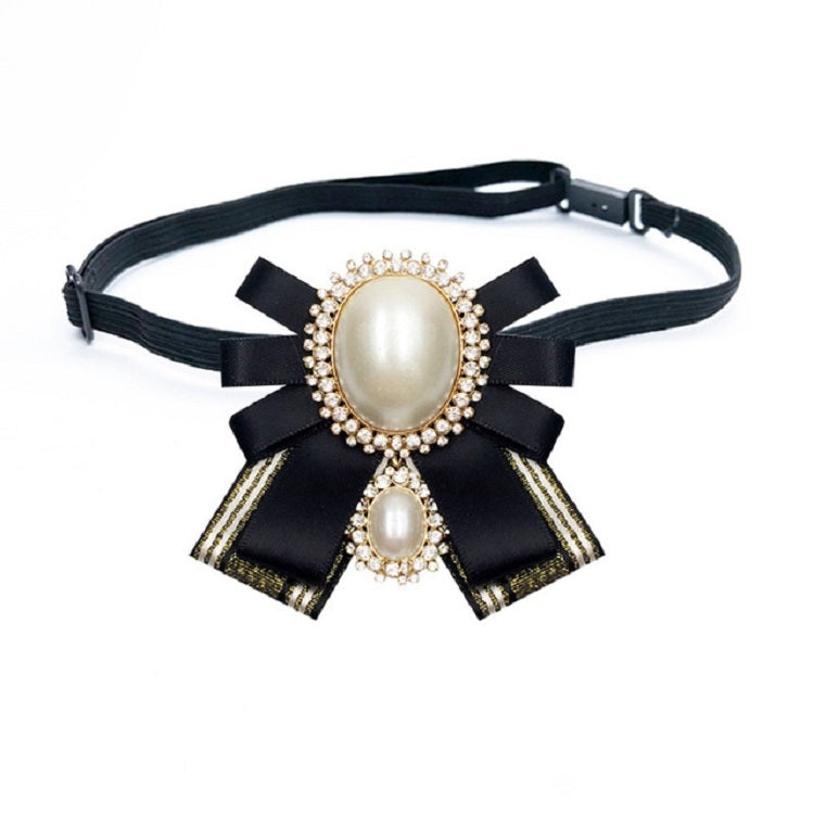 Black fabric bow brooch with oval pearl centers, rhinestone border, attached to a belt strap