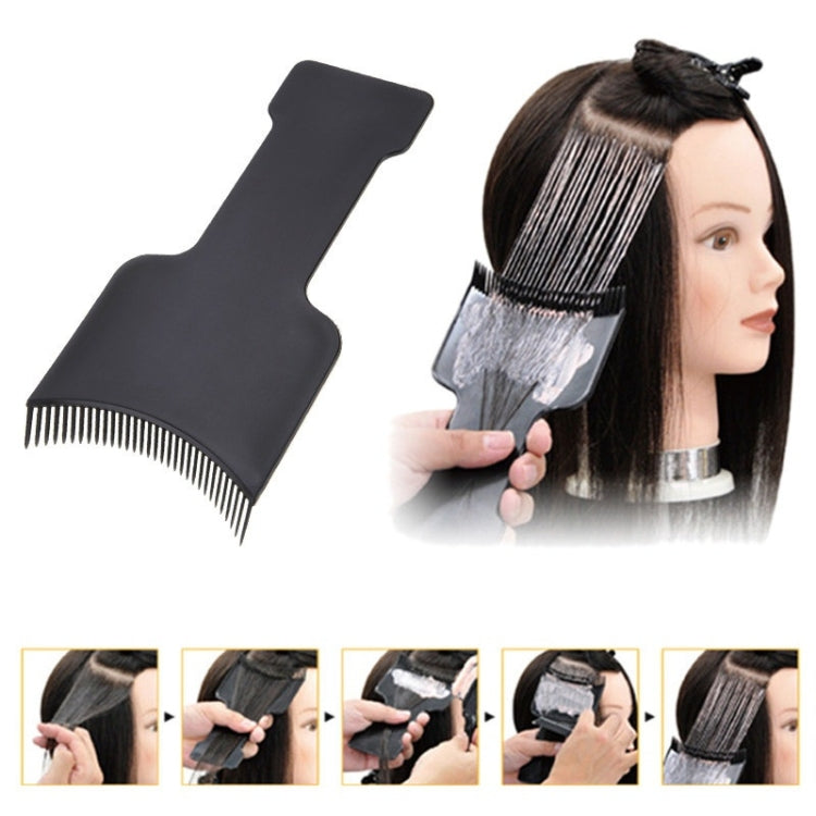 Black hair dye applicator brush with comb teeth, applying color to hair on mannequin