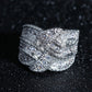Glittering silver zircon wide band ring with swirling layered design