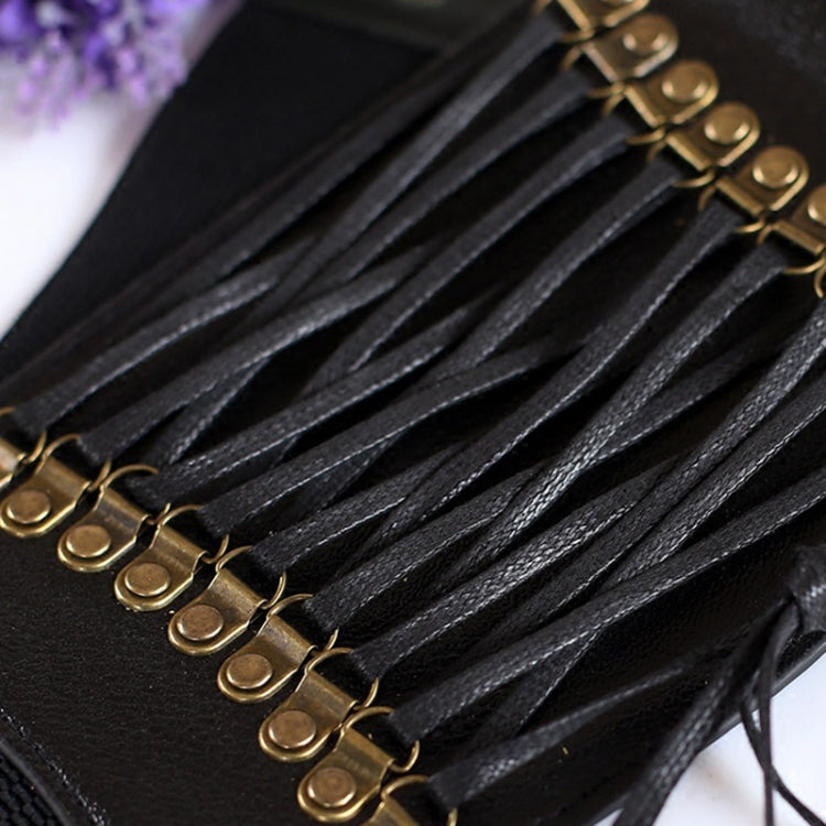 Close-up of black lace-up elastic cords with gold-tone metal eyelet details