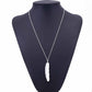 Silver long feather pendant necklace on mannequin