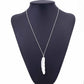 Silver long feather pendant necklace on mannequin