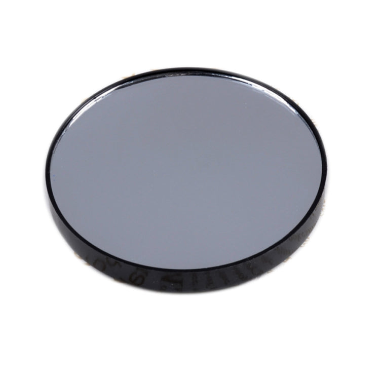 Black round makeup magnification mirror with dark reflective lens and slim frame