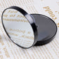 Black round makeup mirror with reflective lens in close-up view