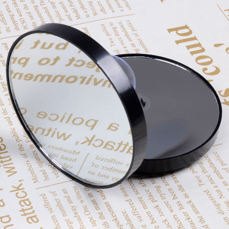 Black round makeup mirror with reflective lens in close-up view