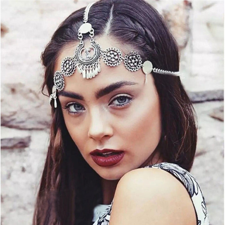Silver coin head chain with crescent and round charms, worn across the forehead