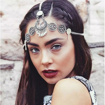 Silver coin head chain with crescent and round charms, worn across the forehead
