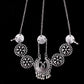 Silver coin head chain with three long strands, round floral medallions, and central crescent charm