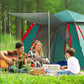 Dark green automatic camping tent with red trim, open door, and raised canopy