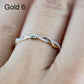 Twist-style cubic zirconia ring on finger, gold-toned metal with bright round stones.