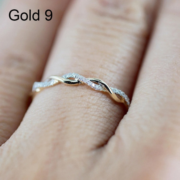 Twist CZ band ring with oval stones, gold-tone setting, close-up on finger