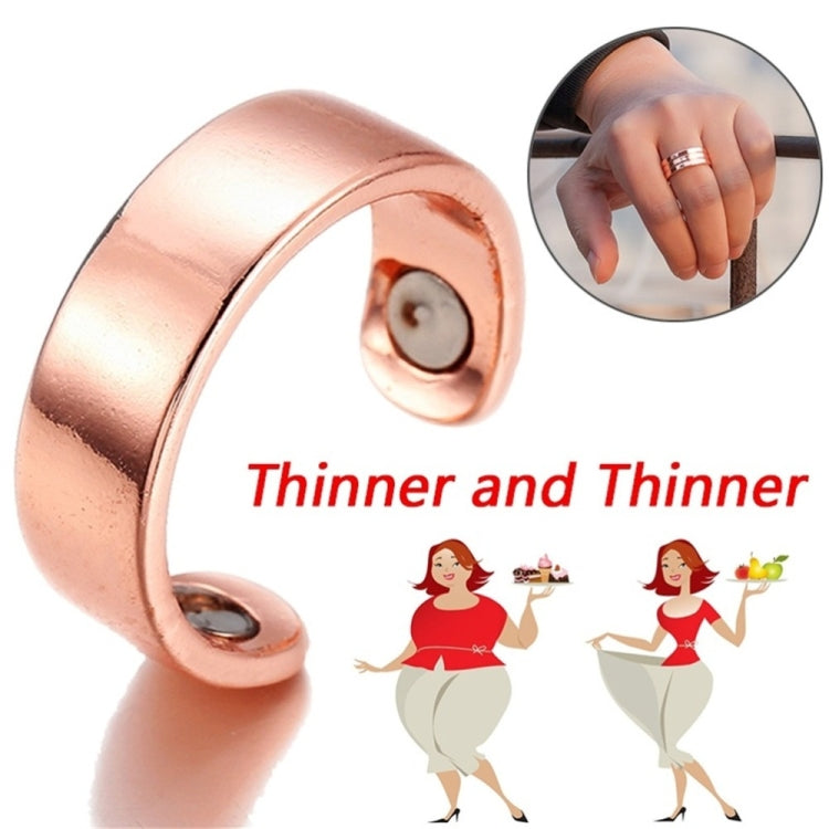 Rose gold open cuff ring angled view with three small magnetic disc details