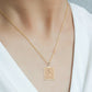 Gold geometric square rose pendant necklace on collarbone with thin chain