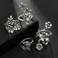 Set of four antique silver floral rings with rose and small flower details