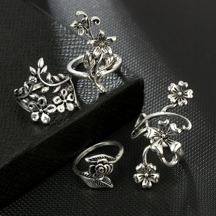 Set of four antique silver floral rings with rose and small flower details