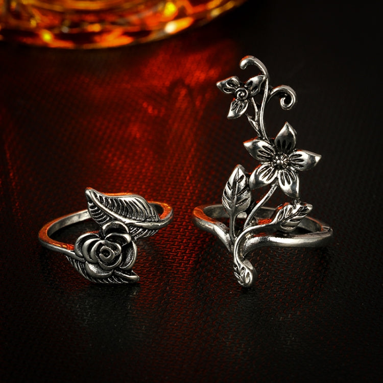 Two antique silver rings with rose and flower accents, including leaf scroll details