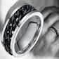 Black chain-link stainless steel ring with polished silver edges, angled close-up