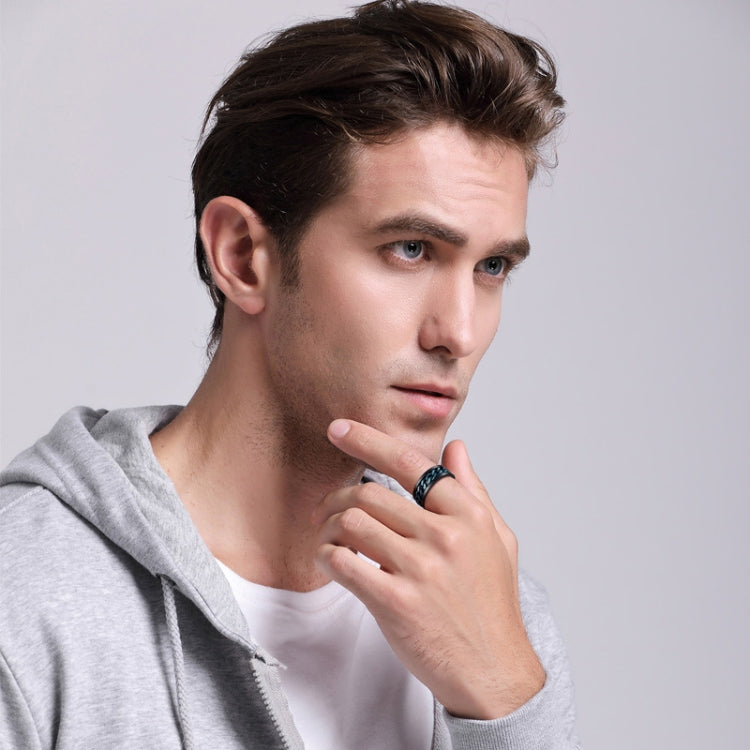 Man wearing a black chain-link stainless steel rotatable ring on his finger