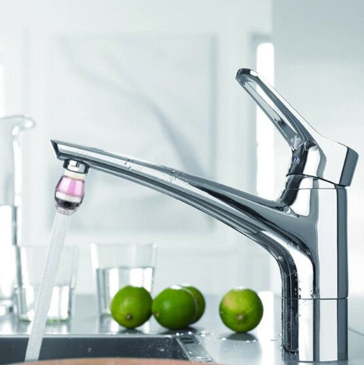 Tap water purifier faucet attachment on chrome kitchen faucet, clear water flow