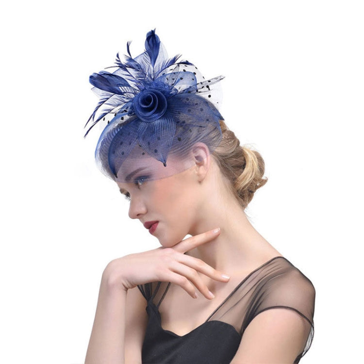 Blue mesh bridal fascinator with feather plume and dotted veil