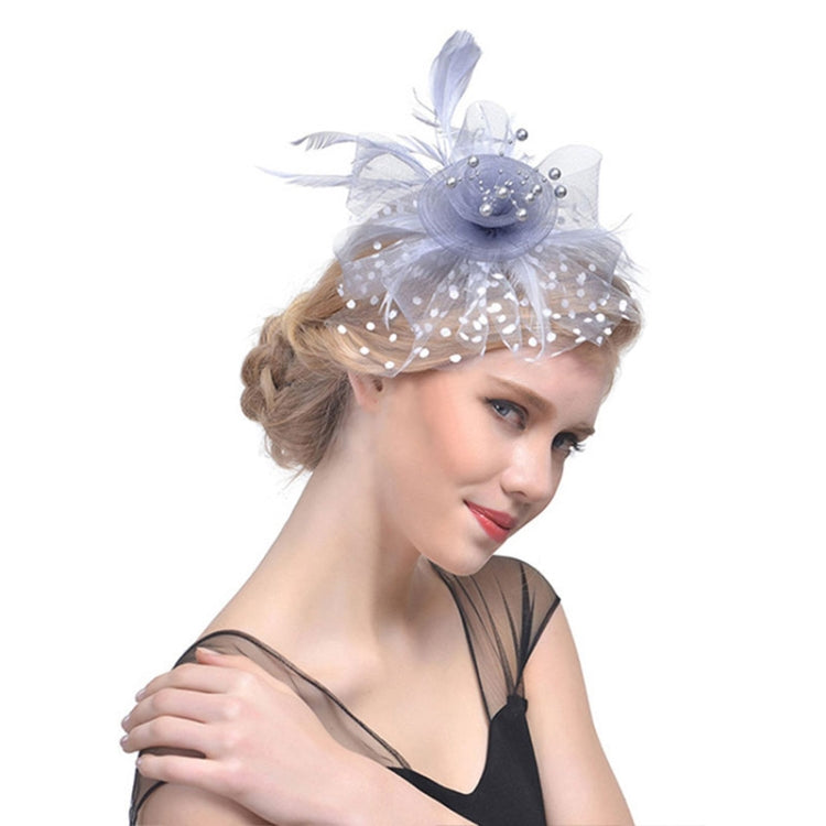 Light blue mesh bridal fascinator with beaded flower and dotted veil