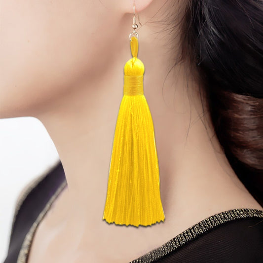 Long yellow tassel earring with a silver-tone fishhook, worn on the ear.