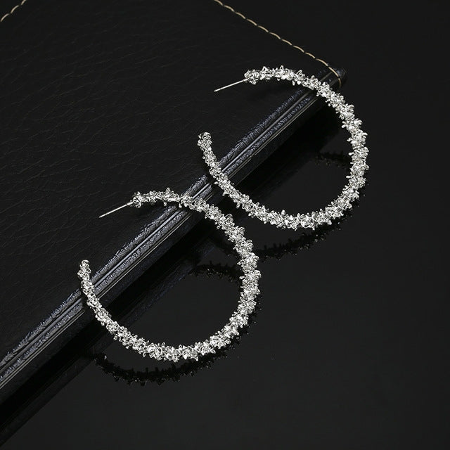 Silver-tone crystal hoop earrings, open teardrop shape, stud backs