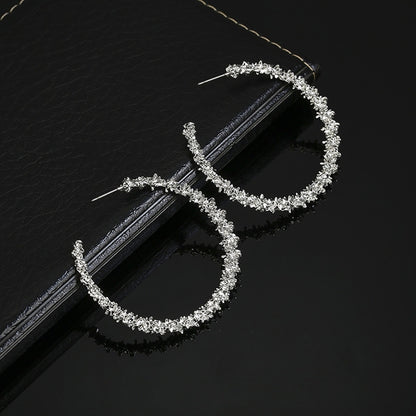Silver-tone crystal hoop earrings, open teardrop shape, stud backs