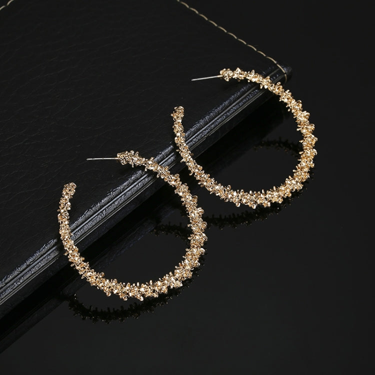 Gold-tone crystal hoop earrings with teardrop hoop profile, stud backs