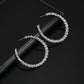 Silver-tone crystal hoop earrings, teardrop curve, stud backs