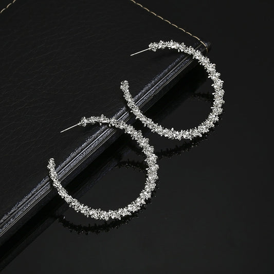 Silver-tone crystal hoop earrings, open teardrop shape, stud backs