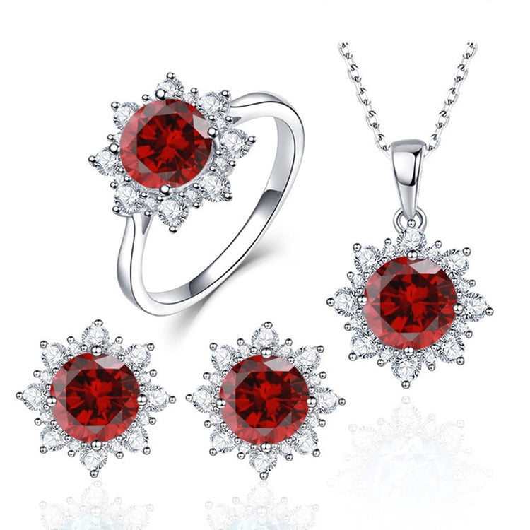 Gemstone jewelry set with red round ring, necklace pendant, and three matching stud earrings.