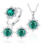Ring, pendant necklace, and stud earrings in silver tone with green oval gemstones.
