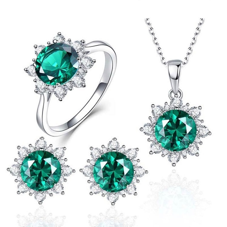 Ring, pendant necklace, and stud earrings in silver tone with green oval gemstones.