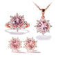 3-piece rose-gold set with pink gemstone ring, pendant necklace, and stud earring pair.