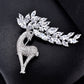 Crystal deer brooch close-up on textured surface, sparkling marquise stones and antlers