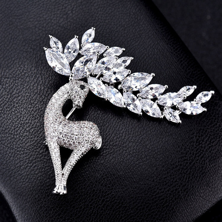 Crystal deer brooch close-up on textured surface, sparkling marquise stones and antlers