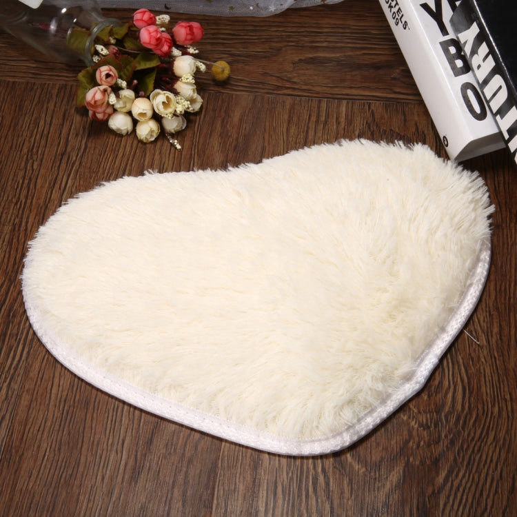 White heart-shaped bath mat with soft fluffy shag pile and non-slip edge trim.